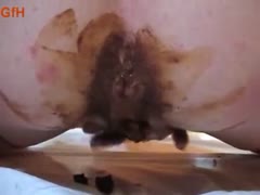 A cute girl fingers her little asshole till excrement emerges.